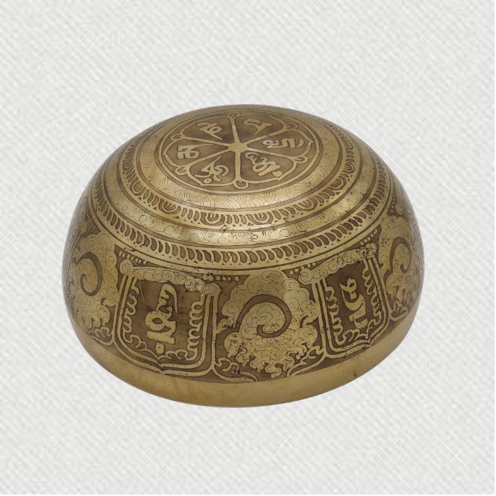 Tibetan Singing Bowl with prayer carved in it.