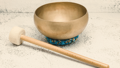 metal singing bowl with a small hammer used for meditation